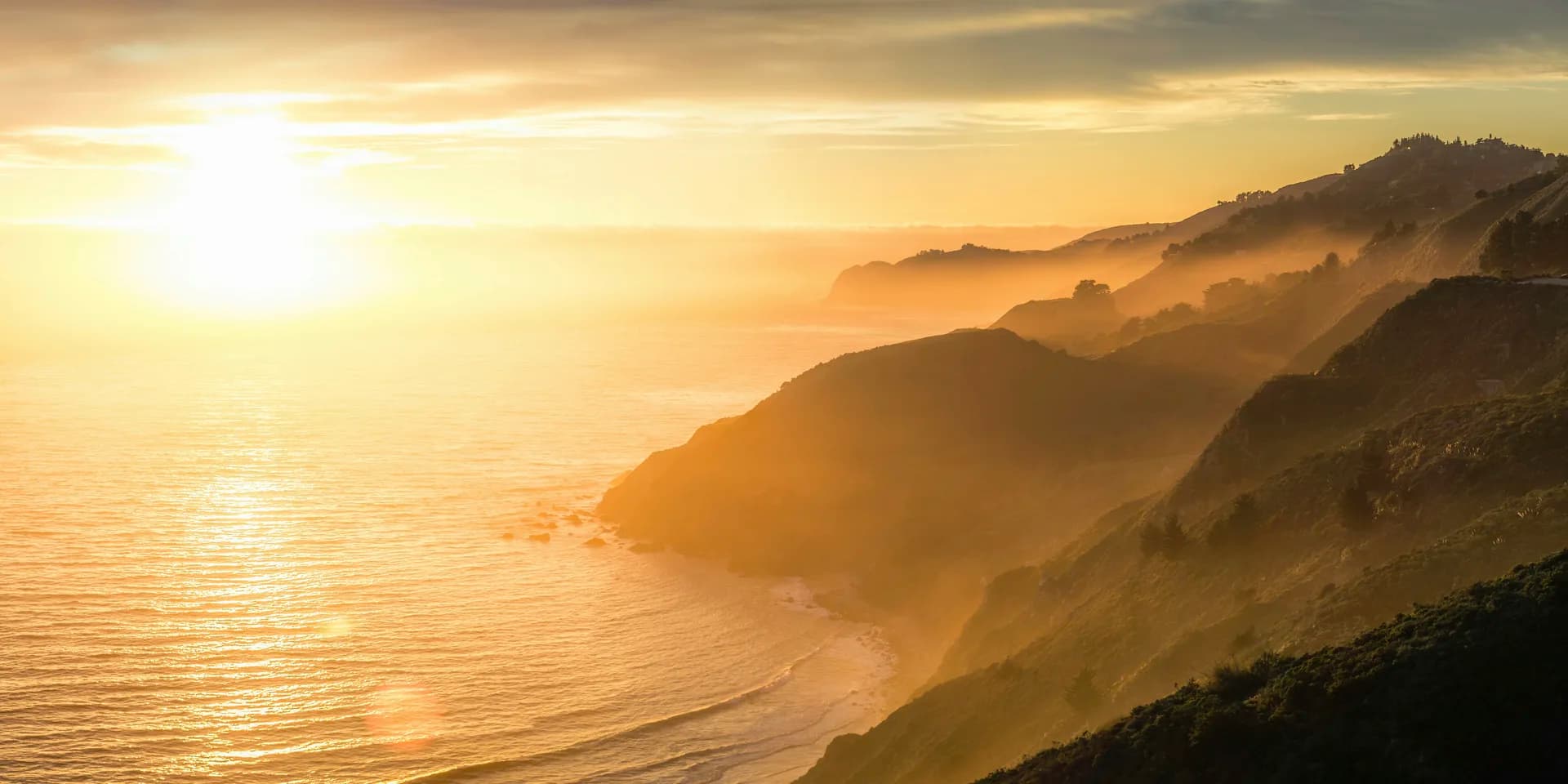 A luminous sunrise breaking over a calm ocean, symbolising the dawn of new awareness and the gentle arrival of truth